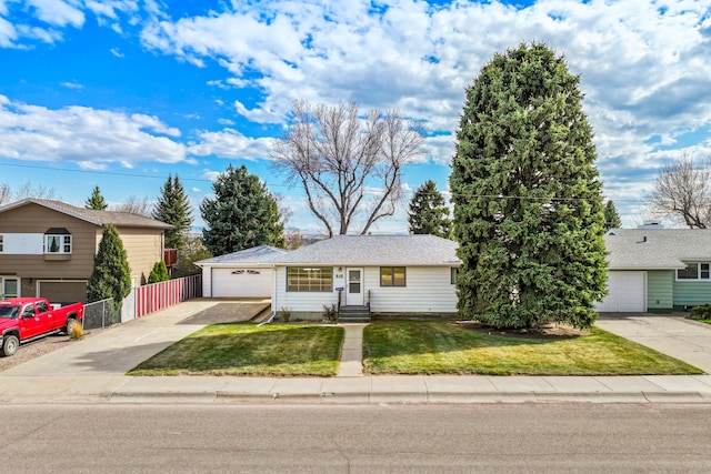 416 Riverview Dr E, Great Falls, MT 59404 - view of front of house with concrete driveway, fence, a front lawn, and a garage