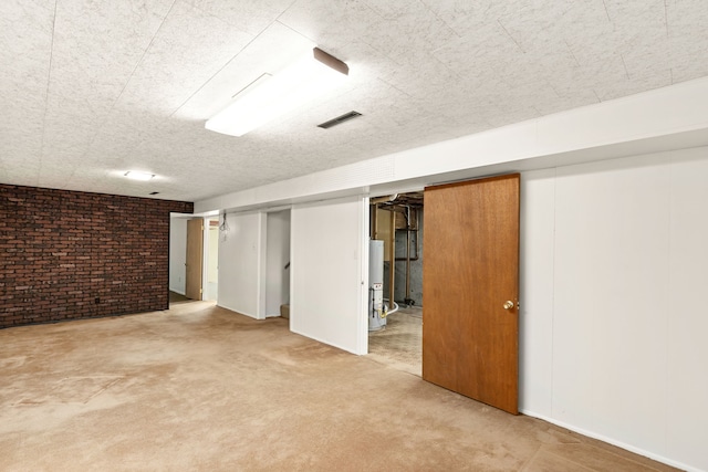 416 Riverview Dr E, Great Falls, MT 59404 - finished below grade area with water heater, carpet flooring, brick wall, and visible vents