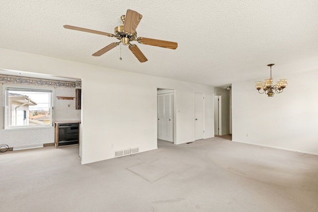 416 Riverview Dr E, Great Falls, MT 59404 - unfurnished room with a textured ceiling, visible vents, baseboards, ceiling fan with notable chandelier, and light carpet