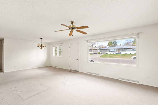 416 Riverview Dr E, Great Falls, MT 59404 - unfurnished living room with visible vents, a wealth of natural light, and ceiling fan with notable chandelier