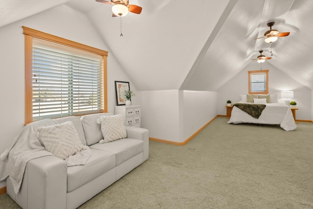 living area featuring a ceiling fan, baseboards, and vaulted ceiling