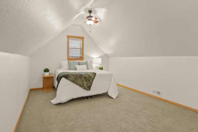 carpeted bedroom with baseboards, a ceiling fan, lofted ceiling, and visible vents