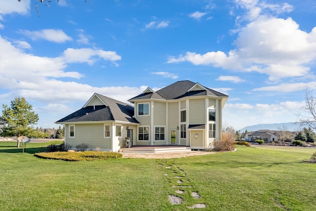 rear view of house with a lawn and a patio