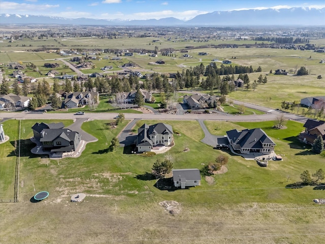 drone / aerial view featuring a residential view and a mountain view