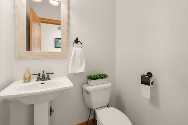bathroom with toilet and a sink