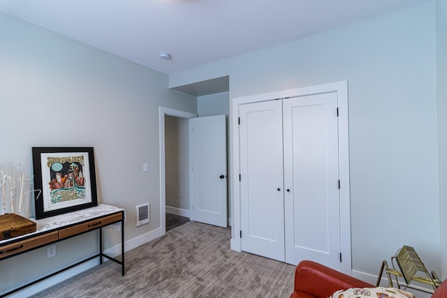sitting room with visible vents, baseboards, and wood finished floors