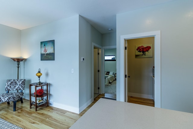 bedroom featuring light wood-style floors and baseboards