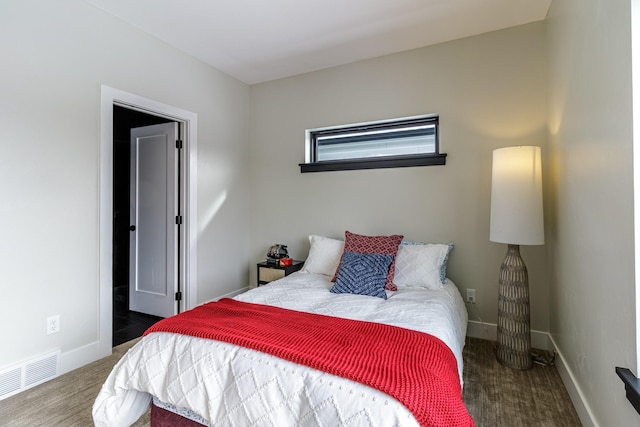bedroom featuring baseboards, carpet flooring, and visible vents