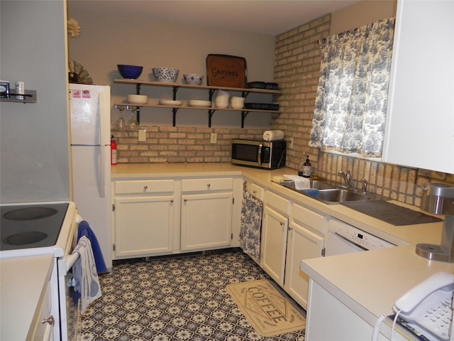 kitchen featuring open shelves, white appliances, light countertops, white cabinets, and a sink