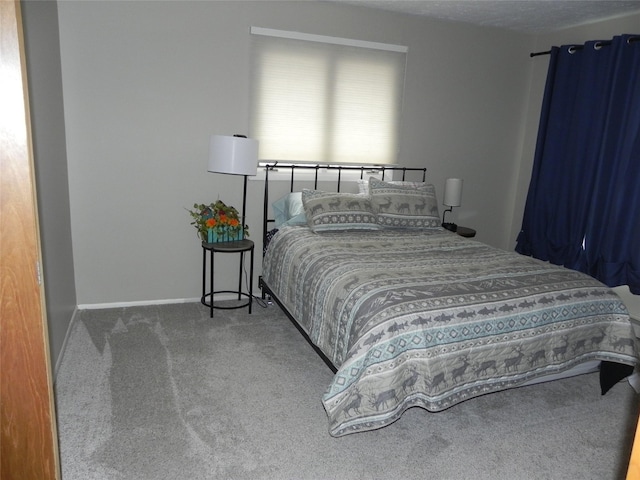 bedroom featuring carpet floors and baseboards