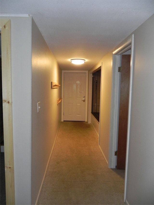 corridor with carpet floors and baseboards