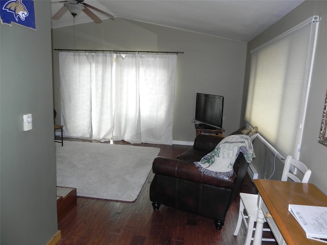 living area with plenty of natural light, ceiling fan, wood finished floors, and vaulted ceiling