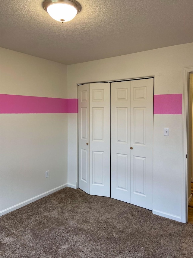 329 35th Ave NE, Great Falls, MT 59404 - unfurnished bedroom featuring carpet floors, a textured ceiling, and a closet