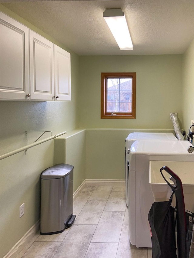 329 35th Ave NE, Great Falls, MT 59404 - laundry area with cabinet space, a textured ceiling, washer and clothes dryer, and light tile patterned floors