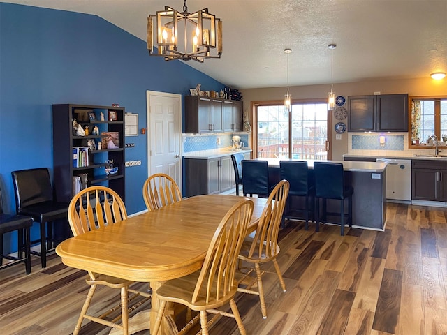 329 35th Ave NE, Great Falls, MT 59404 - dining space with lofted ceiling, a chandelier, and wood finished floors