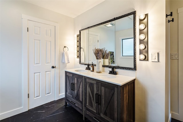bathroom featuring a sink, baseboards, and double vanity