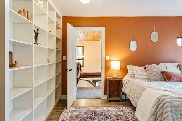 bedroom with baseboards and wood finished floors