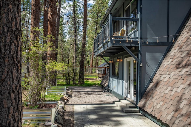view of patio with a balcony and entry steps