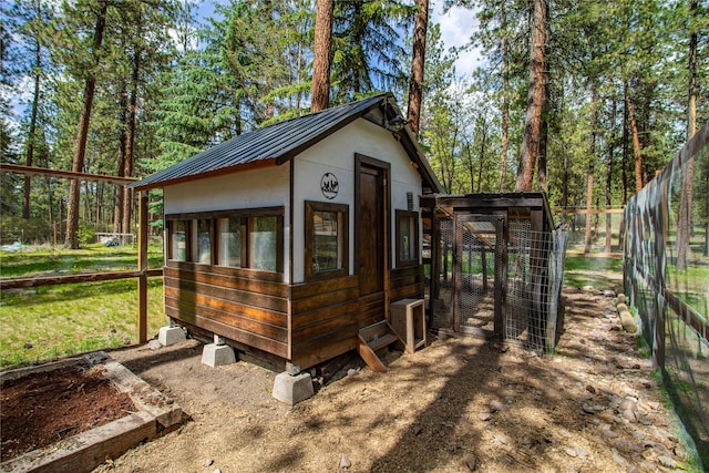 view of poultry coop with a lawn and fence