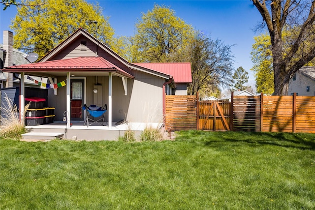 111 6th Ave W, Polson, MT 59860 - back of property with a yard, fence, metal roof, and a gate