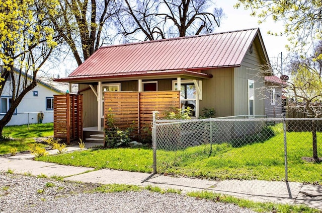 111 6th Ave W, Polson, MT 59860 - view of front facade featuring a porch, metal roof, fence private yard, and a front yard