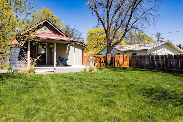 111 6th Ave W, Polson, MT 59860 - rear view of property featuring fence, a yard, and metal roof