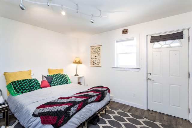 111 6th Ave W, Polson, MT 59860 - bedroom with baseboards, wood finished floors, and track lighting