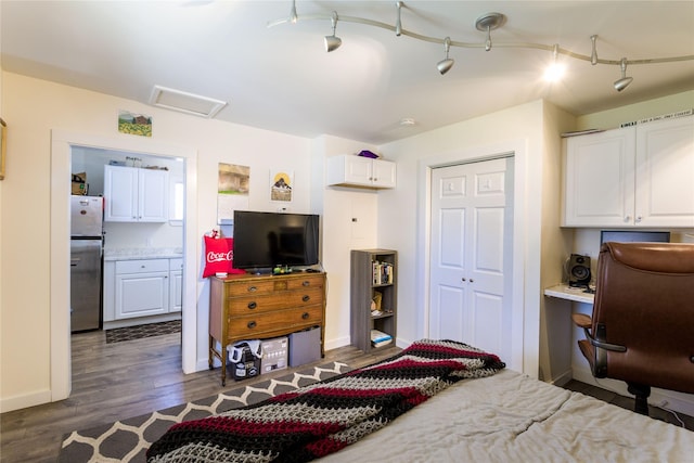 111 6th Ave W, Polson, MT 59860 - bedroom with attic access, freestanding refrigerator, baseboards, dark wood-style floors, and a closet