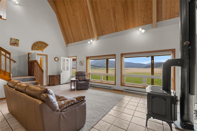 290 Browns Meadow Rd, Kila, MT 59920 - living area with a wood stove, stairs, light tile patterned floors, and high vaulted ceiling