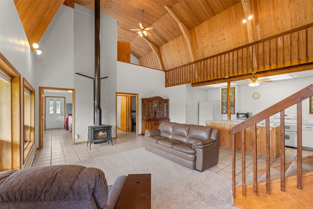 290 Browns Meadow Rd, Kila, MT 59920 - living room with a wood stove, ceiling fan, wooden ceiling, and high vaulted ceiling