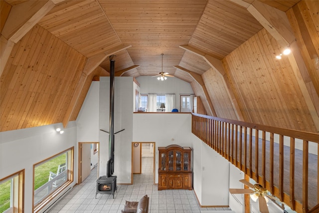 290 Browns Meadow Rd, Kila, MT 59920 - living area featuring plenty of natural light, a wood stove, a ceiling fan, and high vaulted ceiling