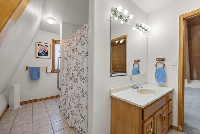 290 Browns Meadow Rd, Kila, MT 59920 - bathroom with tile patterned flooring, vaulted ceiling, vanity, baseboards, and a shower with shower curtain