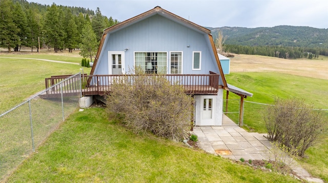 290 Browns Meadow Rd, Kila, MT 59920 - back of property featuring a fenced backyard, a deck with mountain view, and a yard
