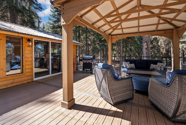 wooden deck featuring a gazebo, an outdoor hangout area, and a grill