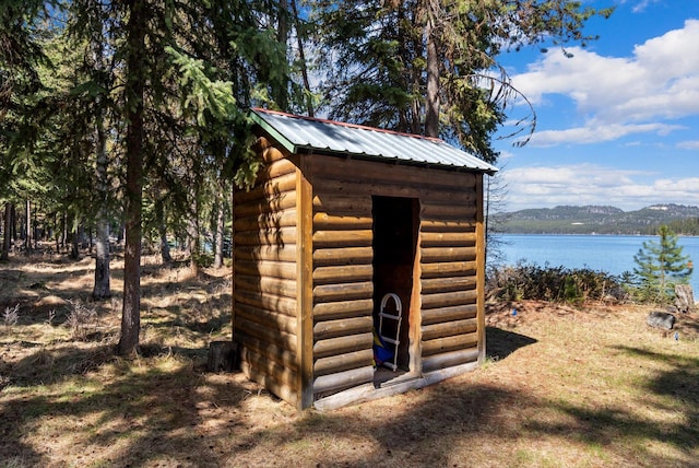view of shed with a water view