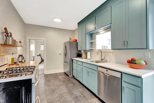 kitchen with open shelves, a sink, light countertops, baseboards, and stainless steel appliances