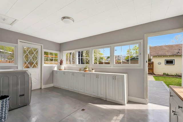 interior space with baseboards and plenty of natural light