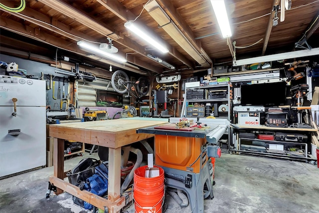 interior space with a workshop area and concrete floors