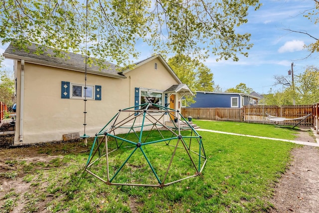 exterior space with fence and a yard