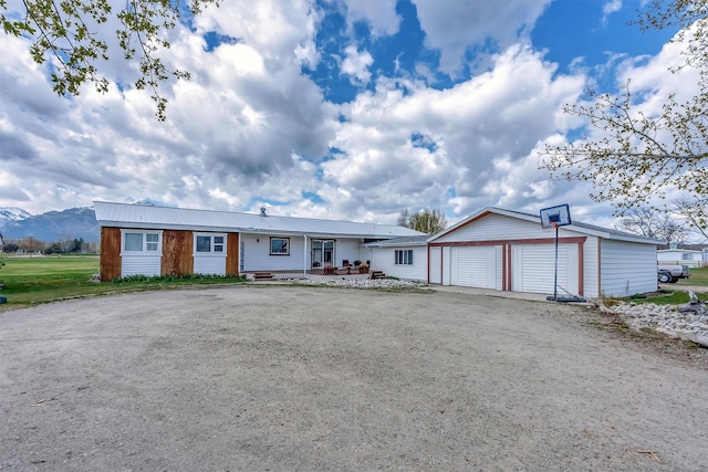 single story home with an outbuilding