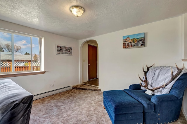 living area featuring carpet floors, arched walkways, a textured ceiling, and baseboard heating