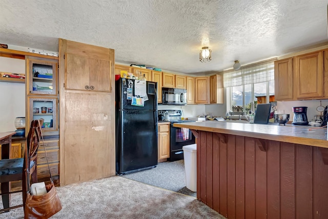 kitchen featuring light colored carpet, a breakfast bar, a textured ceiling, a peninsula, and black appliances