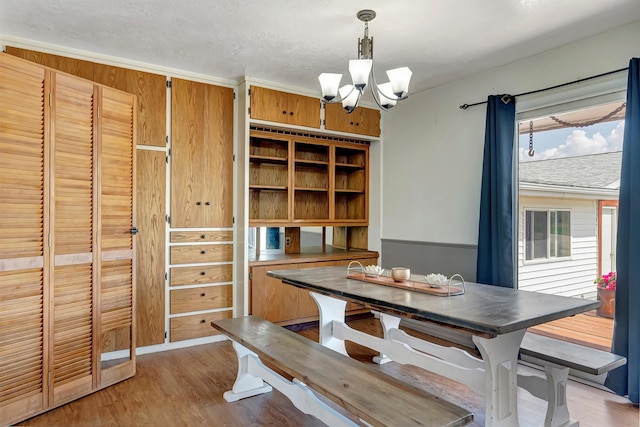 dining space with light wood-style flooring and a chandelier