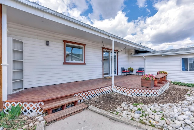 view of exterior entry featuring a deck