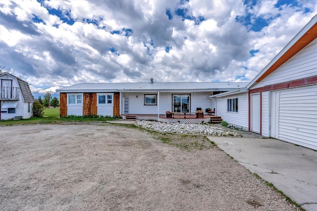 rear view of property with metal roof