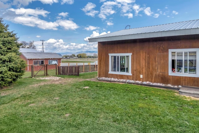 view of yard with fence and a gate
