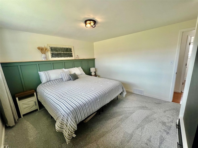 carpeted bedroom featuring visible vents