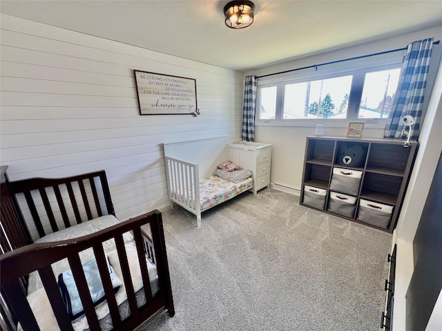 bedroom featuring carpet flooring and wooden walls