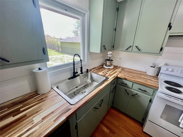 kitchen with a sink, white electric range, butcher block countertops, and dark wood-type flooring