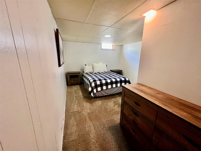 bedroom with carpet flooring and a paneled ceiling